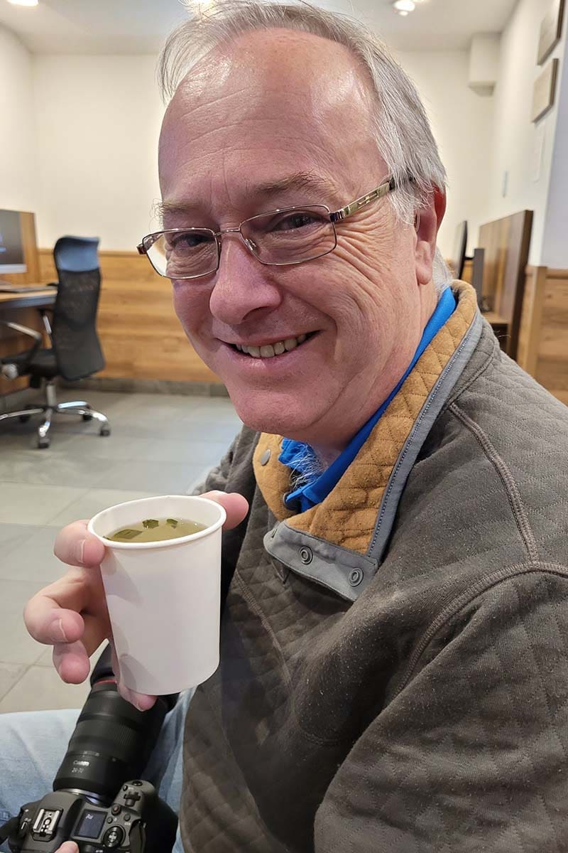 About Me - Neil drinking Coca tea to combat altitude sickness in Cusco, Peru