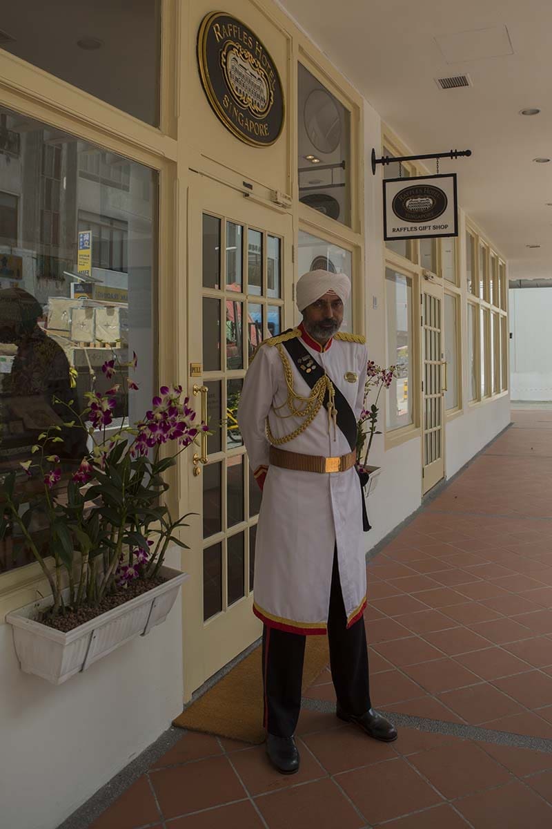 One of the iconic Sikh Doormen at Raffles Hotel, where drinking a Singapore Sling in the Long Bar is one of the 10 Great Things to do in Singapore