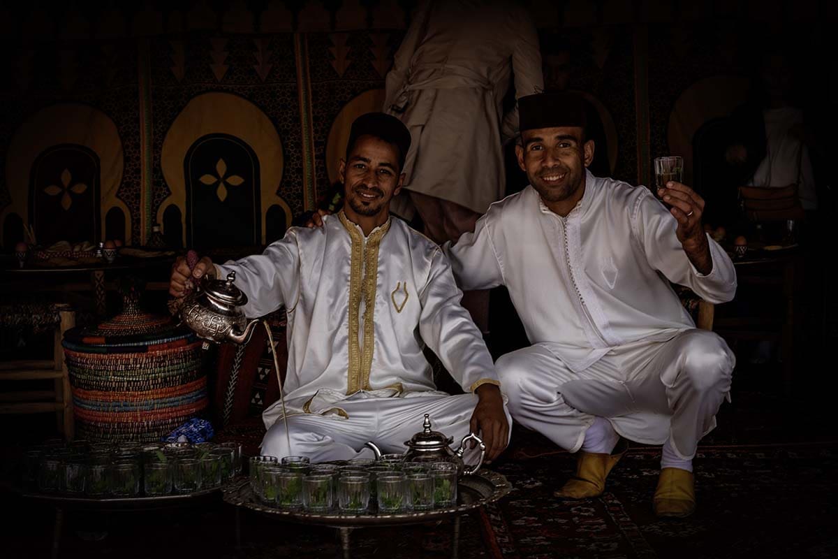 Morocco Travel Guide - Two locals pouring mint tea for guests