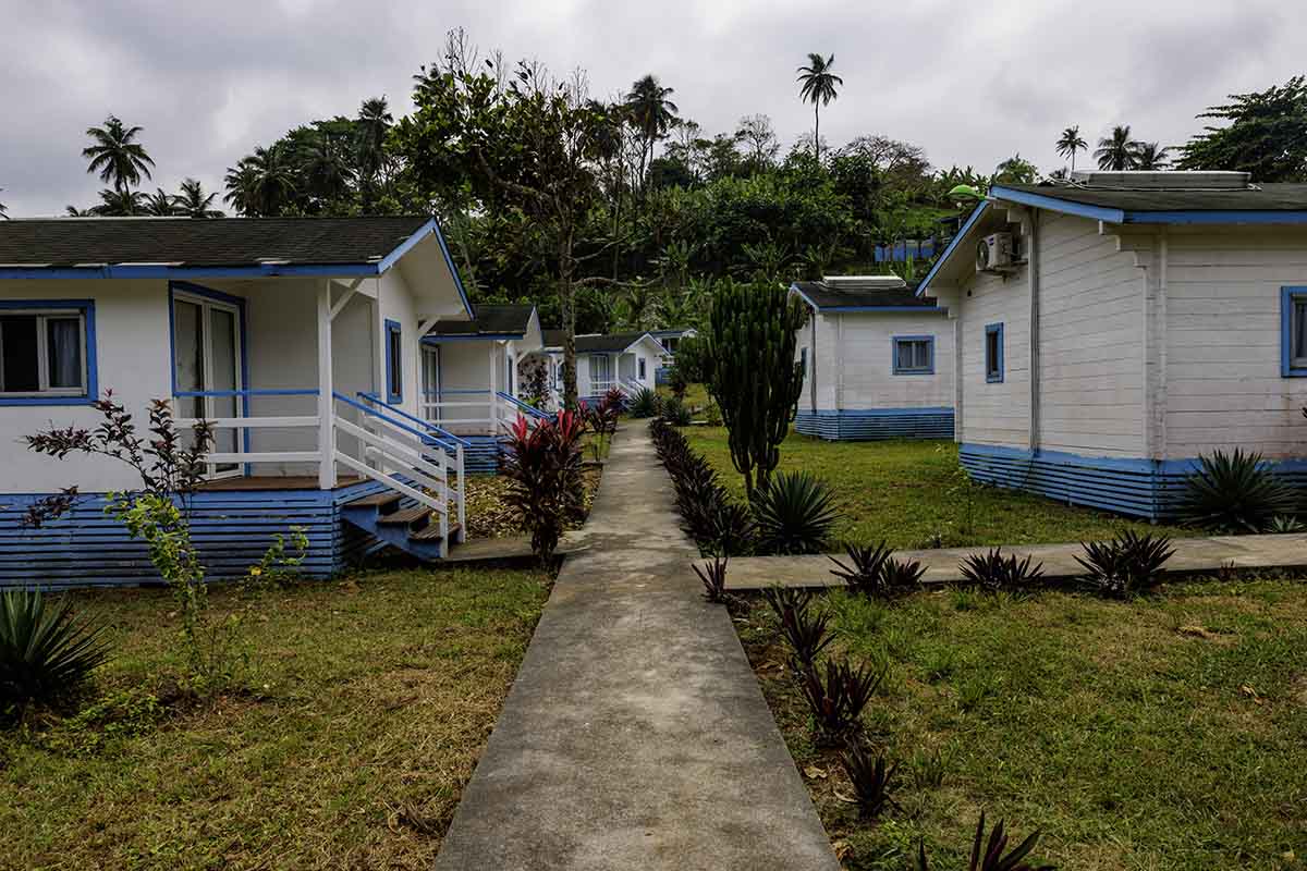 white and blue painted bungalow accommodation at N'Guembú Nature Resort