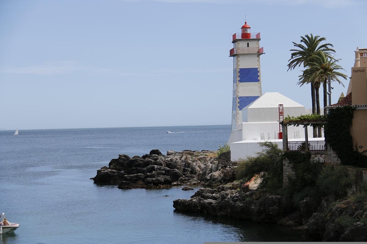 Blue and white striped lighhouse at Cascais - One of the 10 Best Day Trips from Lisbon - Credit Tania Dimas