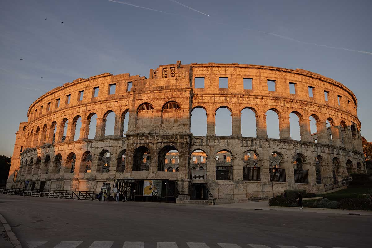 Pula's Roman theatre lit up by the late evening sun